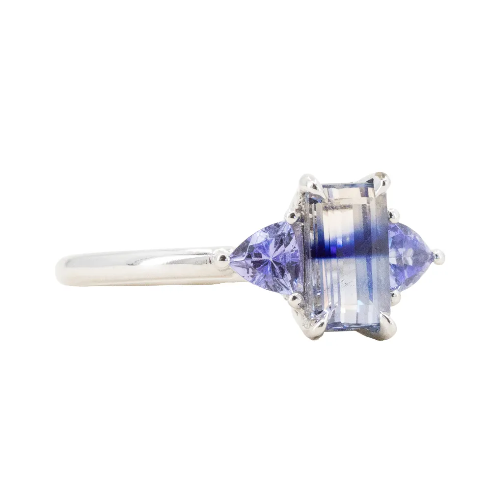 1.11ct Bicolor Emerald Cut Sapphire Three Stone Ring with Tanzanite Trillion Side Stones in Platinum